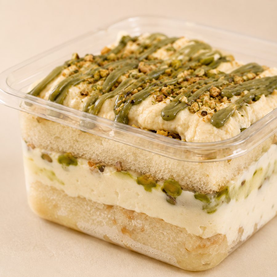 A Persian Love Story dessert, styled with rose petals and pistachio